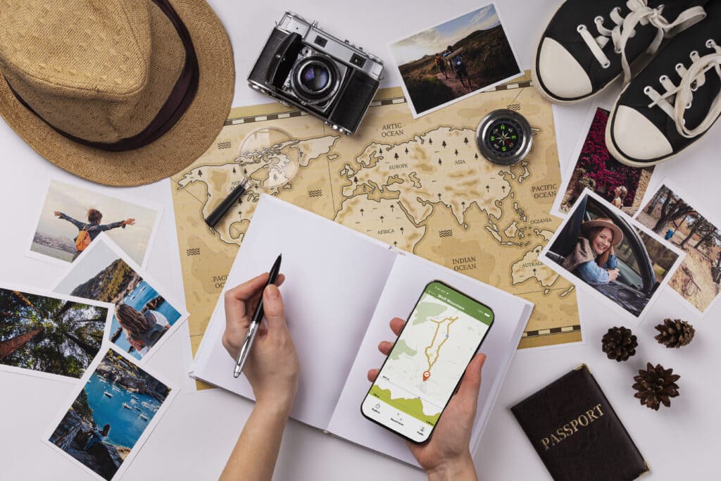 A person holding a pen and notebook planning a trip